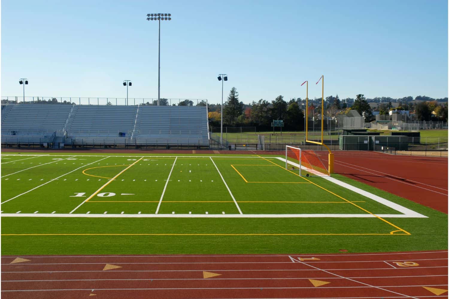 A close-up view of a green American football field in Salt Lake City, showing white yard lines and numbers marking 20, 30, and 40 yards, with clear boundary lines and hash marks on the artificial turf installation.