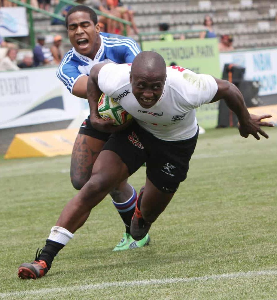 A close-up of a tennis net on a grass court in Salt Lake City, with a white strap securing the center to the ground and crisp white lines marking the sports field—perfect for natural or artificial turf installation.