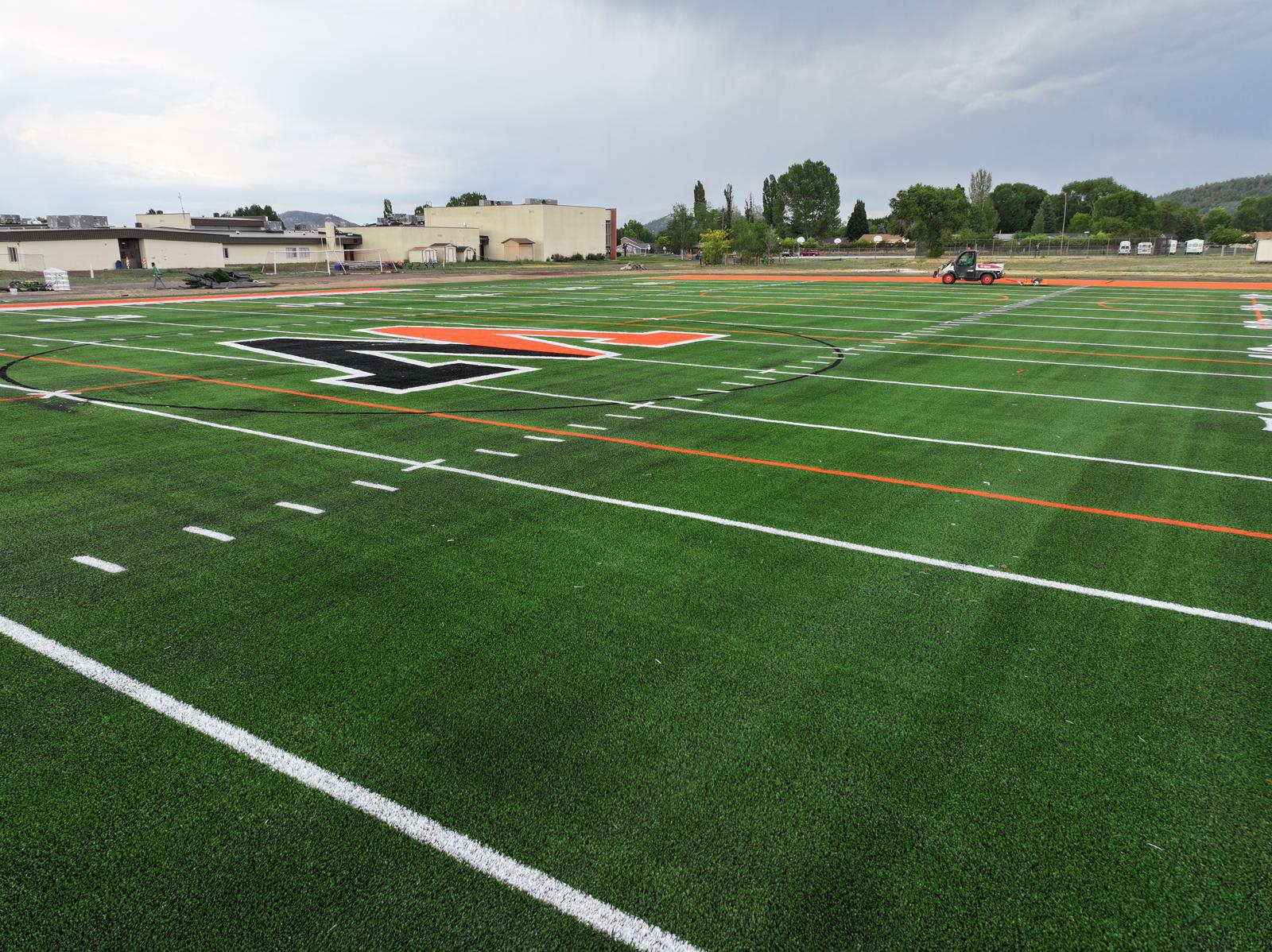 picture of a bright green artificial grass football field that was installed at a college in Arizona by Coyote Sports Turf